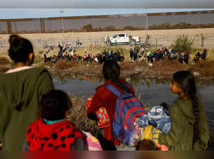 FILE PHOTO: Migrants seeking asylum in the United States gather on the banks of the Rio Bravo river, in Ciudad Juarez