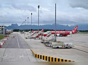 This photo taken on November 17, 2023 shows Air Asia planes parked on the apron at Krabi International Airport.