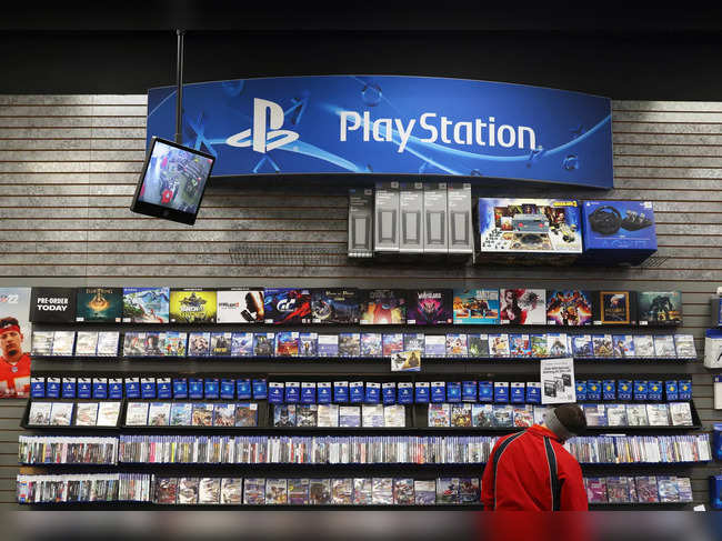 A person looks at PlayStation games in a GameStop in Manhattan, New York