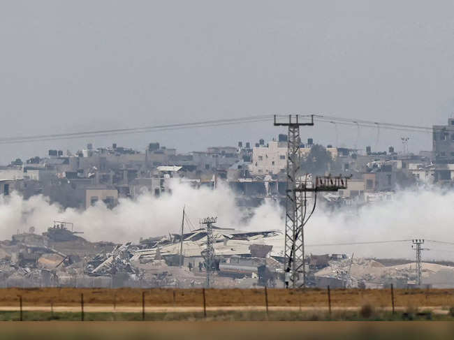 FILE PHOTO: An Israeli military tank and soldiers operate in the Gaza Strip, as seen from southern Israel