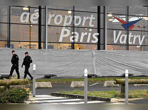 French gendarmes patrol around a terminal at Vatry airport, north-eastern France, on December 23, 2023 two days after officials grounded a Nicaragua-bound plane carrying more than 300 Indian passengers over suspected "human trafficking".
