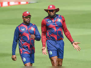Ahmedabad: West Indies captain Kieron Pollard with teammate Darren Bravo during ...