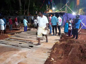 Thiruvananthapuram: Locals at the site after a makeshift bridge at Neyyattinkara...