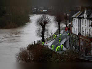 Environment Agency workers prepare the flood barriers along the River Severn in Ironbridge after heavy rain from Storm Gerrit