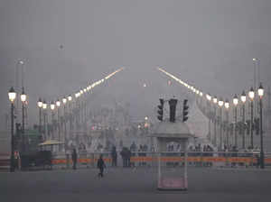 New Delhi: Commuters on Kartavya Path amid dense evening fog, in New Delhi. (PTI...