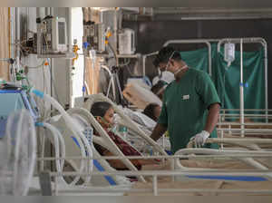 Bengaluru: A male nurse attends a patient inside an ICU at Rajiv Gandhi Institut...
