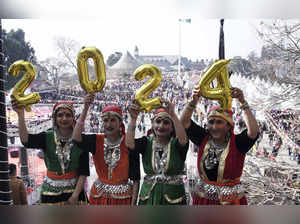 Shimla: Women in traditional Himachali attire hold balloons to form 2024 during ...