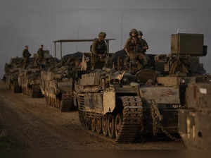 A convoy of Israeli army armoured personnel carriers (APC) is seen near the Isra...
