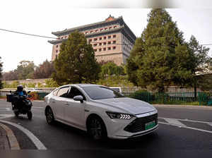 FILE PHOTO: BYD's electric vehicle (EV) Qin moves on a street in Beijing