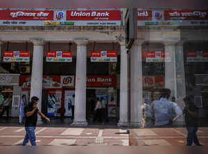 A man walks past a branch of Union Bank of India in New Delhi