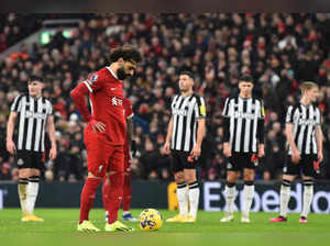 Liverpool's Egyptian striker #11 Mohamed Salah (2L) prepares to take a penalty during the English Premier League football match between Liverpool and Newcastle United at Anfield in Liverpool, north west England on January 1, 2024.