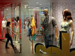 A woman enters a retail store inside a shopping mall in Mumbai, India