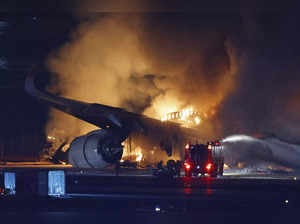 A Japan Airlines plane is on fire on the runway of Haneda airport on Tuesday, Ja...