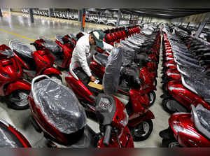 FILE PHOTO: An employee checks a tag on a new scooter at a stock yard during a media tour to the newly inaugurated second assembly line of a Honda Motorcycle & Scooter India manufacturing plant at Vithalapur