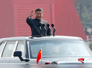 FILE PHOTO: Chinese President Xi Jinping waves from a vehicle as he reviews the troops at a military parade marking the 70th founding anniversary of People's Republic of China