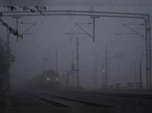 Ajmer, Jan 04 (ANI): A train runs slowly on its track amid dense fog on a cold w...