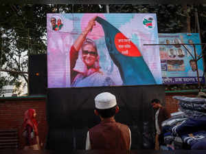 A boy watches an election campaign video of Awami League on a big screen installed on a roadside ahead of the general election, in Dhaka