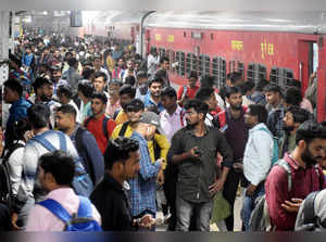 Prayagraj, Oct 29 (ANI): Students rush to board a train after appearing in the U...