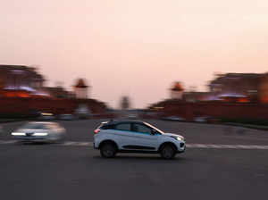 An electric vehicle is driven on the road near India's Rashtrapati Bhavan Presidential Palace in New Delhi