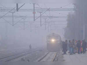 Ajmer: A train arrives at the Adarsh Nagar railway station amid dense fog, in Aj...