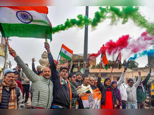 Bikaner: Congress supporters celebrate after party's leader Rupinder Singh Koona...