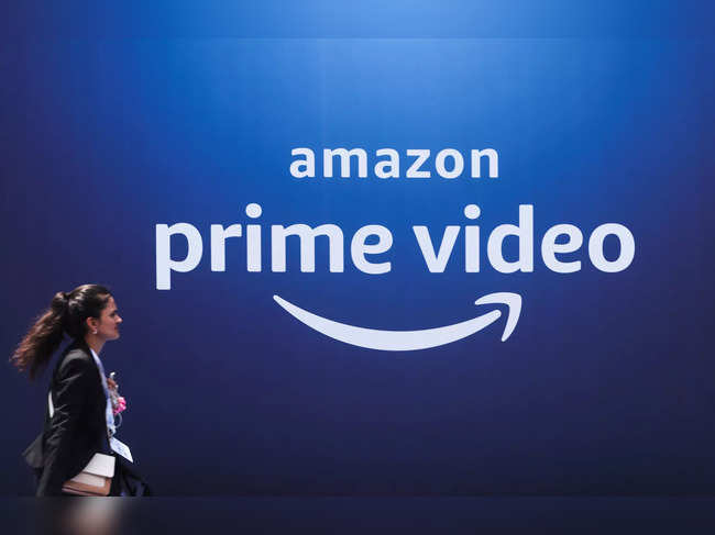 A woman walks past a hoarding of Amazon Prime Video during an event in Mumbai