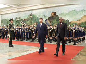 The photo taken on January 10, 2024 shows Maldives' President Mohamed Muizzu (R) and Chinese President Xi Jinping walking during a welcome ceremony at the Great Hall of the People in Beijing.