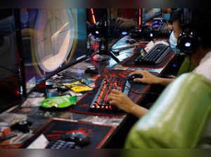 Man plays online game on a computer at an internet cafe in Beijing