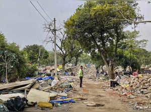**EDS: WITH STORY** New Delhi: People at a slum area after the demolition of set...
