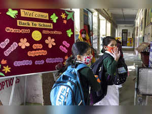 New Delhi: Students arrive to attend a class after schools reopened for nursery ...