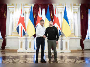 Ukrainian President Volodymyr Zelensky shakes hands with Britain's Prime Minister Rishi Sunak (L) during a meeting at the Presidential Palace in Kyiv on January 12, 2024.