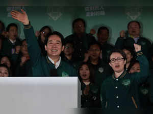 Taiwan's President-elect Lai Ching-te (L) waves beside his running mate Hsiao Bi-khim during a rally outside the headquarters of the Democratic Progressive Party (DPP) in Taipei on January 13, 2024, after winning the presidential election.