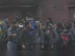 New Delhi: Students wearing a face mask outside a school as air quality continue...