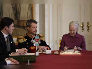 Queen Margrethe II of Denmark (R) signs a declaration of abdication as Crown Prince Frederik of Denmark becomes King Frederik X of Denmark (C) and Prince Christian of Denmark reacts in the Council of State at the Christiansborg Castle in Copenhagen, Denmark, on January 14, 2024.