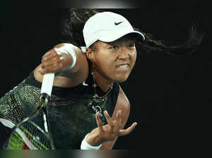 Japan's Naomi Osaka serves against France's Caroline Garcia during their women's singles match on day two of the Australian Open tennis tournament in Melbourne on January 15, 2024.