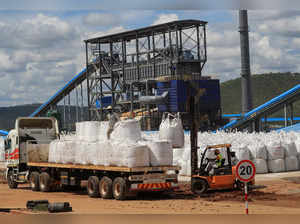 Workers load lithium concentrate at Prospect Lithium Zimbabwe mine in Goromonzi