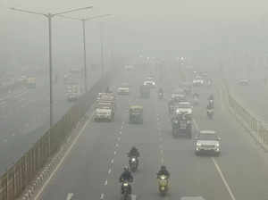 Faridabad: Vehicles move on Delhi-Agra highway amid low visibility due to a thic...