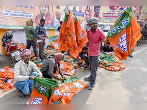 Patna, Jan 10 (ANI): A worker displays the Bharatiya Janata Party (BJP) flags du...