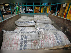 FILE PHOTO: A view shows Ambuja Cement bags, to be carried to a construction site, in a load carrier in Ahmedabad