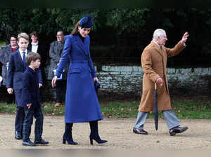 Britain's Catherine, Princess of Wales (C) walks away from the church with Britain's Prince George of Wales (L) and Britain's Prince Louis of Wales (2L) as Britain's King Charles III (R) waves to well-wishers after attending the Royal Family's traditional Christmas Day service at St Mary Magdalene Church on the Sandringham Estate in eastern England, on December 25, 2023.