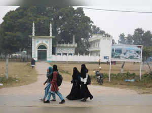 Ayodhya: Muslim women walk past the land allocated for the construction of Muham...