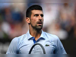 Serbia's Novak Djokovic looks on as he plays against USA's Taylor Fritz during their men's singles quarter-final match on day 10 of the Australian Open tennis tournament in Melbourne on January 23, 2024.