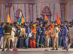 Ayodhya: Police personnel stand guard to manage the crowd as they wait for 'dars...
