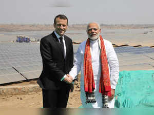 Indian Prime Minister Narendra Modi and French President Emmanuel Macron pose during the inauguration of a solar power plant in Mirzapur