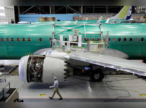 FILE PHOTO: A worker walks past Boeing's new 737 MAX-9 under construction at their production facility in Renton, Washington