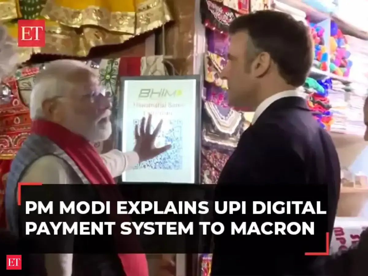 PM Modi explains UPI system to French President Macron outside local ...