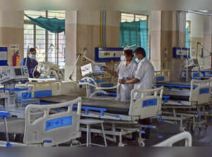 Hyderabad: Healthcare workers arrange medical equipments and beds at the Governm...