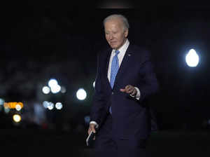 President Joe Biden walks across the South Lawn of the White House in Washington...