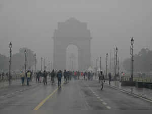 New Delhi, Jan 31 (ANI): Visitors enjoy mild rain while walking on Kartavya Path...