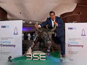 FILE PHOTO: Paytm founder and CEO Vijay Shekhar Sharma poses with a bronze replica of a bull after the company's IPO listing ceremony at BSE in Mumbai